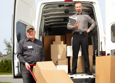 Local movers handling furniture in a residential street near St Pauls Cray