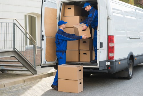 Professional moving team handling items safely with insurance and PPE support