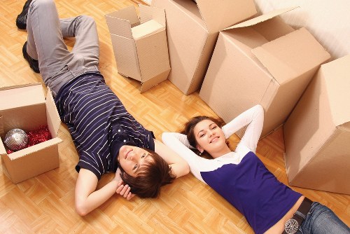 Professional movers loading a van in a residential street