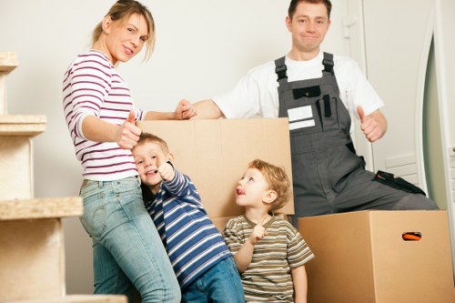 Local removals van helping with moving boxes and furniture